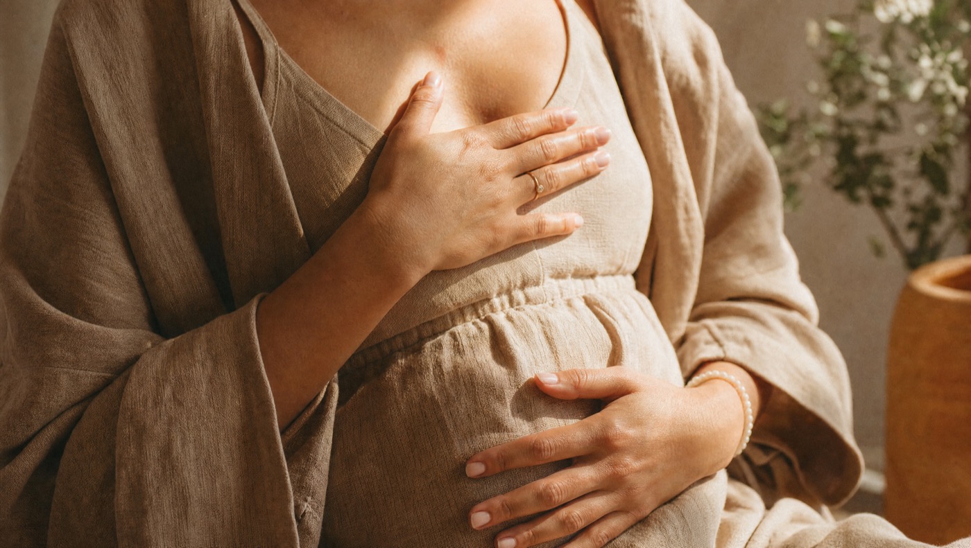 Hands resting gently over the heart in a gesture of self-compassion